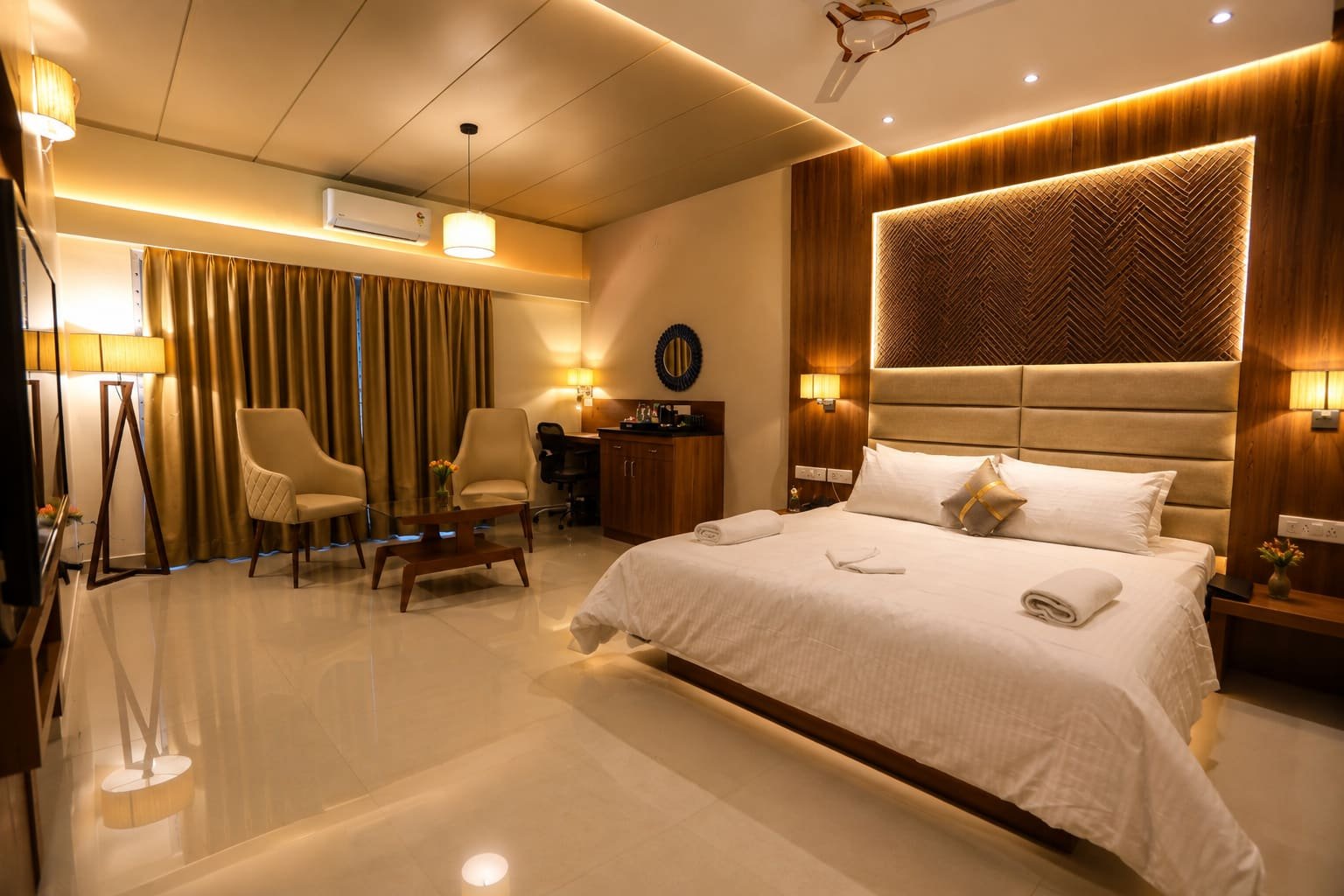 Air-conditioned bridal suite at Vishal Royal with a king bed, lounge seating and warm lighting